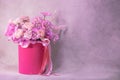 A lush bouquet of pink, purple, peach colour, white cute delicate small roses of different sizes, flowers in cylindrical bright bo Royalty Free Stock Photo