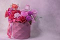 A lush bouquet of red, purple, light pink, white cute delicate small roses of different sizes, flowers in round paper box with geo Royalty Free Stock Photo