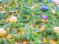 A lush Christmas tree with a luminous garland, blue and gold balls. Full screen photo