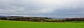 Lush green fields, hills and forests of Ardennes on a misty cloudy day Royalty Free Stock Photo