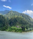 A Lush Green Hill With Cold Neelum RIver in Front Royalty Free Stock Photo