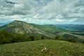 The lush green Kraishte mountain ranges in Bulgaria, Europe, in spring, against a dramatic cloud backdrop