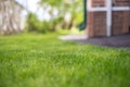 A lush green lawn with a house in the background Royalty Free Stock Photo