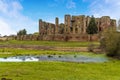 The lush green meadow and a small lake on the `Great Mere`, Kenilworth, UK looking towards the ruins of the Kenilworth castle Royalty Free Stock Photo