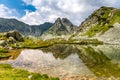 Mountain reflection into glacier lake from Retezat Mountains, Romania Royalty Free Stock Photo