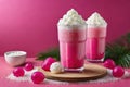 Lush pink bubble tea adorned with fluffy whipped cream and chewy tapioca pearls on a festive backdrop.