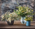 Lush summer bouquets of wildflowers in three vases