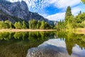 Trees and Sentinel Rock reflect in the smooth  Merced River in Yosemite national park Royalty Free Stock Photo