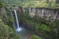 Lush tropical forest gorge with waterfall