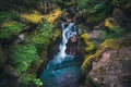Lush waterfall flowing over boulders. Glacier National Park, Montana, USA Royalty Free Stock Photo