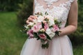 Lush wedding bouquet of white and pink peonies, roses.