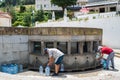 Luso, PORTUGAL - June 14, 2022 - Two elderly men Collecting plastic water bottles by the famous water in public Fountain Royalty Free Stock Photo