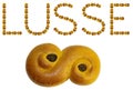 Lusse in text made of real yellow saffron buns, called lussebulle, or lussekatt. The holiday Lucia is also called Lusse in Sweden