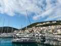 Lustica, Montenegro - 01 november 2023: Lustica bay marina with moored yachts and colorful houses at the foot of the