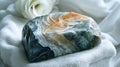 Lustrous Seraphinite showing off its feathery, angelic patterns, softly laid on a white velvet surface