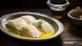 Lutefisk - Traditional Norwegian dish of dried fish rehydrated, on a white plate with melted butter Royalty Free Stock Photo