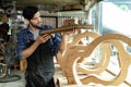 Guitar Luthier Examines Wood for Acoustic Guitar Neck