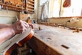 luthier carving the shape of the outside of the front of a violin with gouge Royalty Free Stock Photo