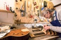 Luthier concentrating on carving a lute Royalty Free Stock Photo