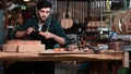 Luthier creating a guitar, clamps on the body of a guitar under construction improving glue adhesion