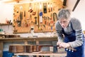 Luthier filing the frets of an acoustic guitar