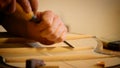 Luthier making a guitar structure with a chisel
