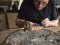 Luthier modifies the head of classical guitar. Royalty Free Stock Photo
