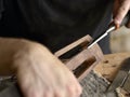 Luthier modifies the head of classical guitar. Royalty Free Stock Photo