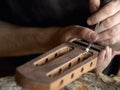 Luthier modifies the head of classical guitar. Royalty Free Stock Photo