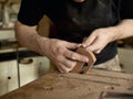 Luthier modifies the head of classical guitar. Royalty Free Stock Photo