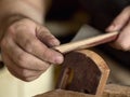 Luthier modifies the head of classical guitar. Royalty Free Stock Photo
