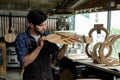 Luthier Taps Acoustic Guitar Wood to Check Sound Quality