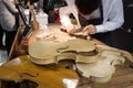 Luthier working on a violin at Bit 2014, international tourism exchange in Milan, Italy Royalty Free Stock Photo