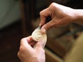 Luthier working on violin head and curl