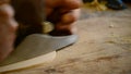 Luthier working with a wood planer