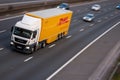 DHL lorry in motion on British motorway M1 Royalty Free Stock Photo