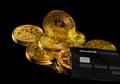 Lutsk, Ukraine - May 1, 2021: Golden coin with bitcoin logo and credit card by monobank. Crypto currency BTC and bitcoin