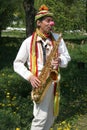 Lutsk, Ukraine - May, 02, 2009: Street musician. The clown plays the saxophone