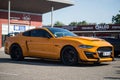 Profile view of orange and white ford mustang 500 GT cars parked in the street Royalty Free Stock Photo