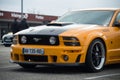 Front view of orange and black ford mustang 500 GT cars parked in the street Royalty Free Stock Photo