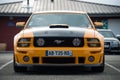 Front view of orange and black ford mustang 500 GT cars parked in the street Royalty Free Stock Photo