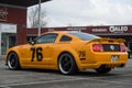 Profile view of orange and black ford mustang 500 GT cars parked in the street Royalty Free Stock Photo