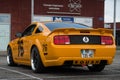 Rear view of orange and white ford mustang 500 GT cars parked in the street Royalty Free Stock Photo