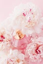 Luxe fragrance bottle as girly perfume product on background of peony flowers, parfum ad and beauty branding