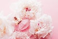 Luxe fragrance bottle as girly perfume product on background of peony flowers, parfum ad and beauty branding