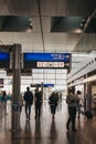 People walking past directional signs in Luxembourg City airport Royalty Free Stock Photo