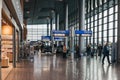 People walking past directional signs in the terminal of Luxembourg airport Royalty Free Stock Photo