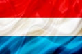 Luxembourg country flag on silk or silky waving texture Royalty Free Stock Photo