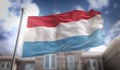 Luxembourg Flag 3D Rendering on Blue Sky Building Background Royalty Free Stock Photo