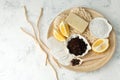 Luxery Set for anti-cellulite massage. Coffee scrub, coffee grains, sea salt, lemon, essential oil, soap, sponge on wooden plate